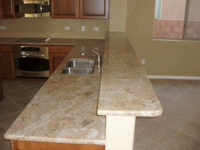 Inspiration for a mid-sized u-shaped ceramic tile kitchen remodel in Phoenix with a double-bowl sink, raised-panel cabinets, medium tone wood cabinets, granite countertops, beige backsplash, stainless steel appliances and a peninsula