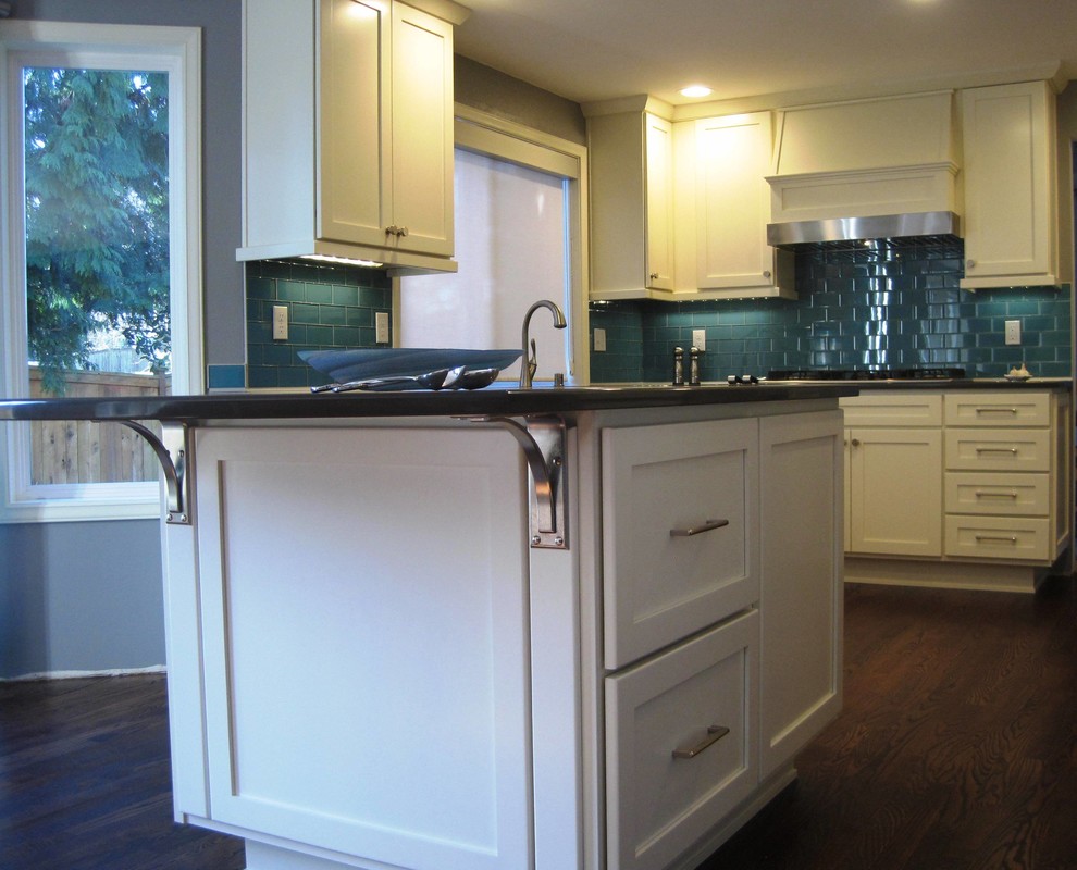 Inspiration for a mid-sized transitional u-shaped dark wood floor open concept kitchen remodel in Seattle with an undermount sink, shaker cabinets, white cabinets, quartz countertops, blue backsplash, glass tile backsplash, stainless steel appliances and a peninsula