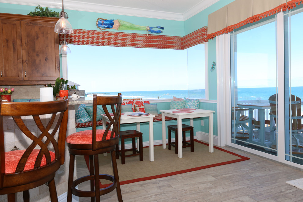 Design ideas for a mid-sized beach style kitchen/dining combo in Orlando with blue walls, porcelain floors, beige floor and no fireplace.