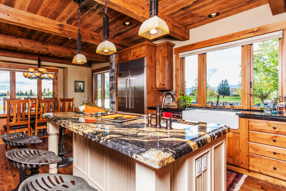Open concept kitchen - mid-sized rustic l-shaped dark wood floor open concept kitchen idea with a farmhouse sink, shaker cabinets, medium tone wood cabinets, granite countertops, multicolored backsplash, stone tile backsplash, stainless steel appliances and an island