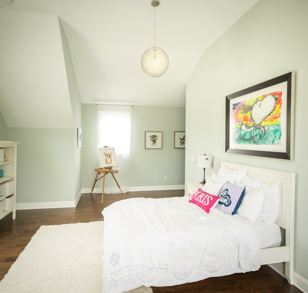This is an example of a traditional kids' bedroom for girls in Atlanta with green walls and dark hardwood floors.