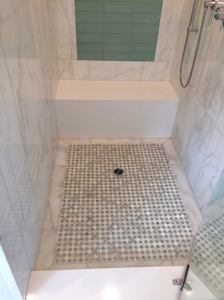 Mid-sized beach style master bathroom in Orange County with flat-panel cabinets, white cabinets, an undermount tub, an alcove shower, a one-piece toilet, white tile, stone tile, white walls, marble floors, an undermount sink, engineered quartz benchtops, white floor, a hinged shower door and white benchtops.