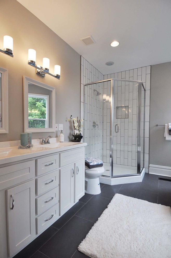 Photo of a mid-sized transitional master bathroom in St Louis with an undermount sink, shaker cabinets, white cabinets, marble benchtops, a claw-foot tub, a corner shower, grey walls and ceramic floors.