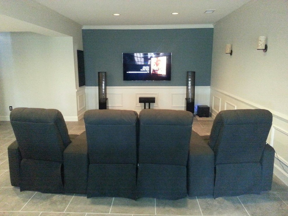 This is an example of a mid-sized transitional open concept home theatre in Atlanta with grey walls, ceramic floors, a wall-mounted tv and brown floor.