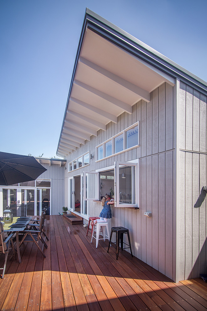 This is an example of a large beach style backyard deck in Melbourne.