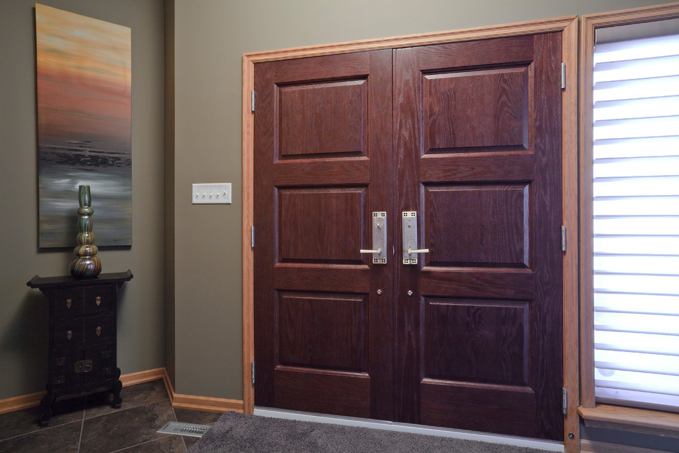 Expansive contemporary front door in Other with yellow walls, slate floors, a double front door, a medium wood front door and brown floor.