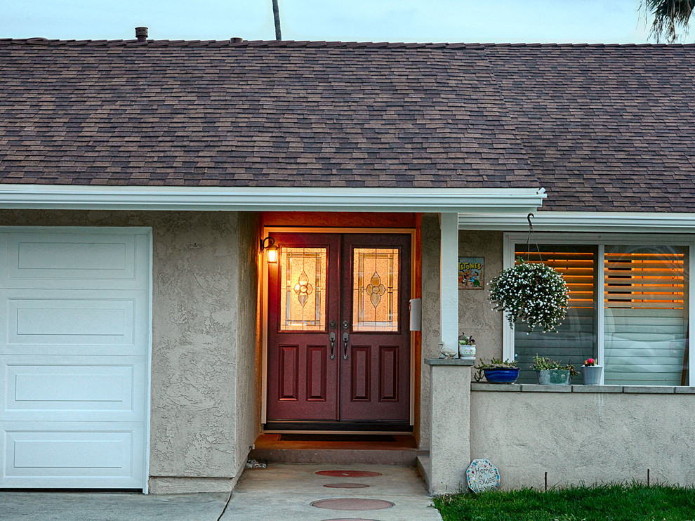 Photo of a large traditional front door in Orange County with grey walls, a double front door and a medium wood front door.