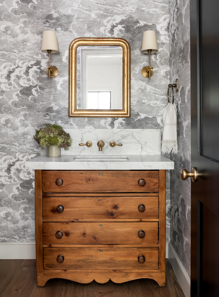 Inspiration for a country powder room in Seattle with furniture-like cabinets, medium wood cabinets, grey walls, dark hardwood floors, an undermount sink, brown floor and grey benchtops.