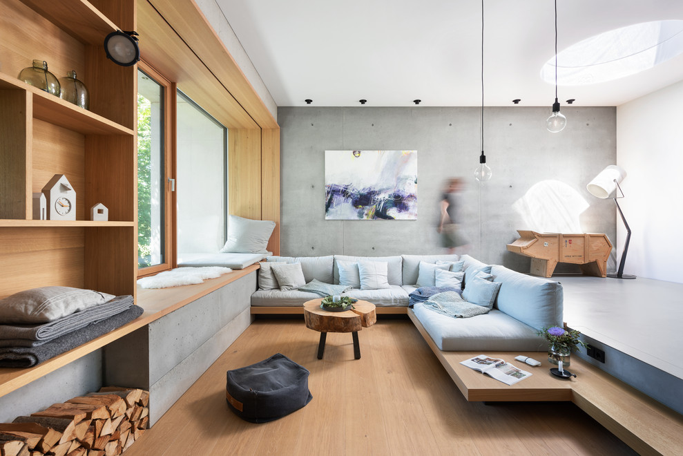 Photo of an expansive scandinavian open concept living room in Munich with grey walls, light hardwood floors and beige floor.