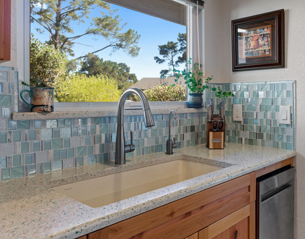 Photo of a kitchen in Other with an undermount sink, shaker cabinets, medium wood cabinets, recycled glass benchtops, multi-coloured splashback, mosaic tile splashback, stainless steel appliances, no island and multi-coloured benchtop.