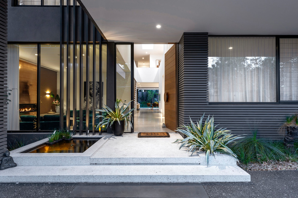 Design ideas for a large contemporary front door in Melbourne with white walls, concrete floors, a single front door, a medium wood front door and white floor.