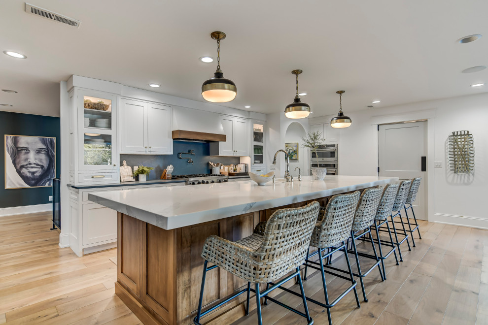 Design ideas for a large transitional galley eat-in kitchen in Chicago with an undermount sink, quartz benchtops, blue splashback, stone slab splashback, stainless steel appliances, light hardwood floors, with island, white benchtop, shaker cabinets, grey cabinets and beige floor.