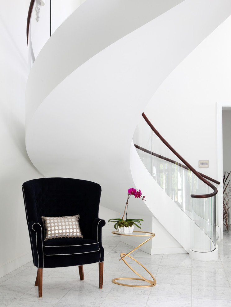 Expansive contemporary curved staircase in Other with mixed railing.
