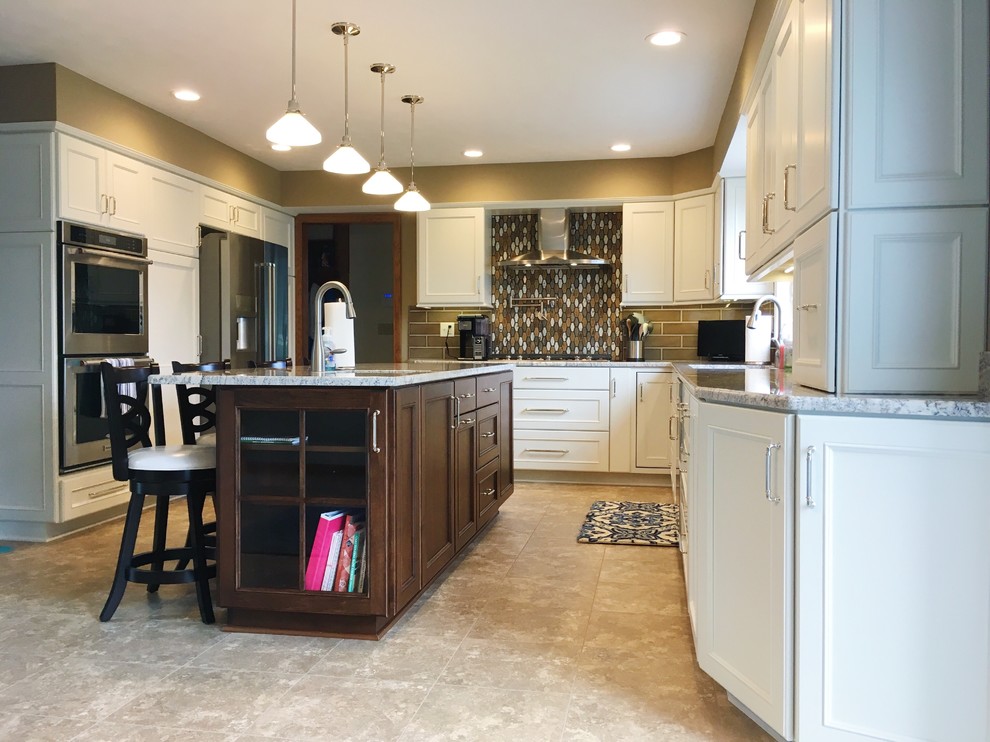 Inspiration for a large transitional l-shaped vinyl floor and beige floor eat-in kitchen remodel with a double-bowl sink, recessed-panel cabinets, white cabinets, granite countertops, brown backsplash, ceramic backsplash, stainless steel appliances and an island