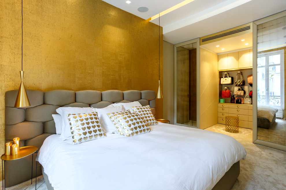 This is an example of a contemporary bedroom in Paris with carpet and beige floor.