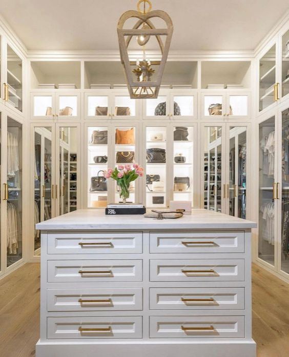 Large contemporary women's walk-in wardrobe in Orlando with shaker cabinets, white cabinets, laminate floors, yellow floor and coffered.