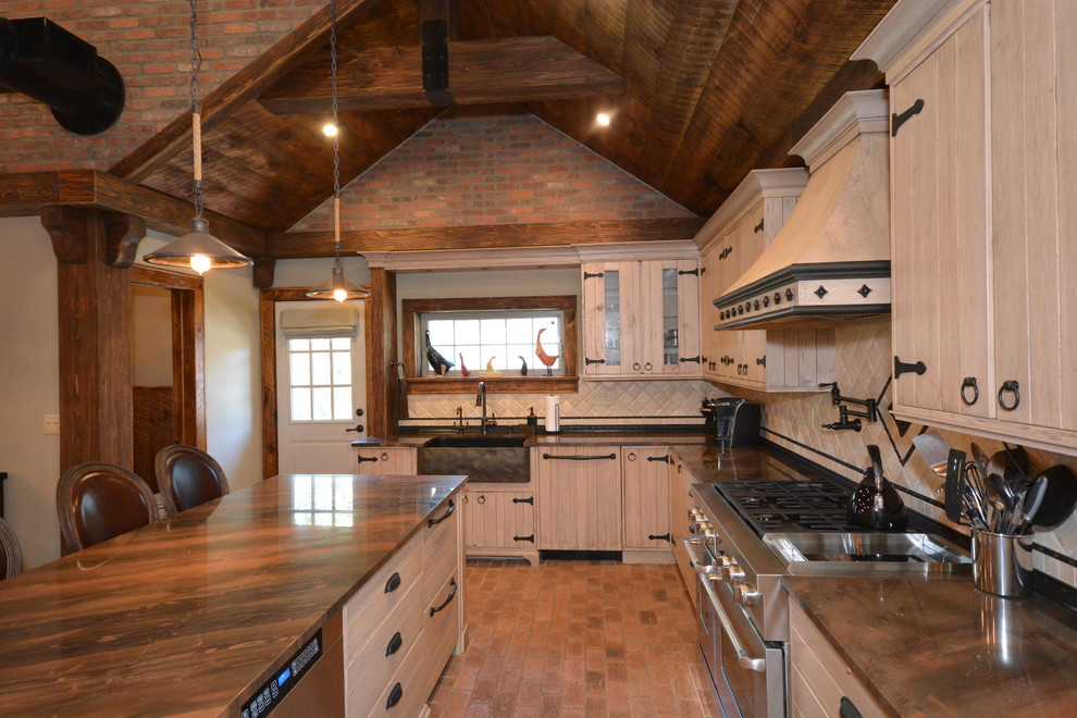 Inspiration for a large rustic l-shaped brick floor and orange floor eat-in kitchen remodel in New York with a farmhouse sink, beige cabinets, quartzite countertops, beige backsplash, limestone backsplash, stainless steel appliances and an island