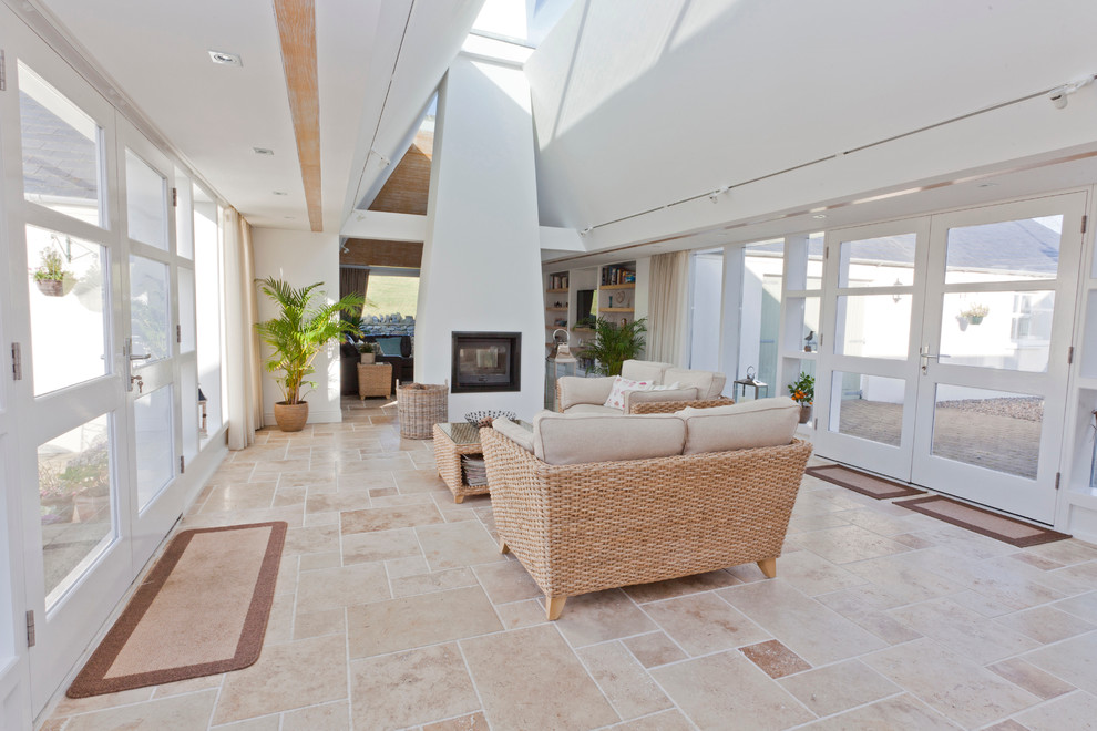 This is an example of a contemporary living room in Belfast with white walls and a two-sided fireplace.
