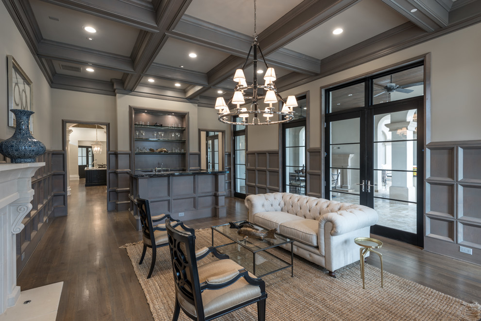 Inspiration for an expansive traditional enclosed living room in Dallas with a home bar, grey walls, medium hardwood floors, a stone fireplace surround and no tv.