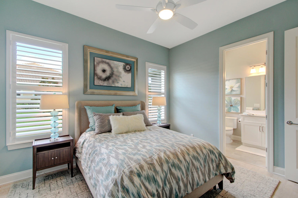 Design ideas for a mid-sized transitional guest bedroom in Orlando with blue walls, light hardwood floors, no fireplace and beige floor.