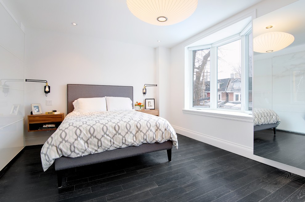 Design ideas for a contemporary bedroom in Toronto with black floor.