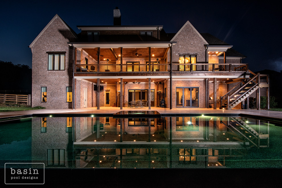 Inspiration for a large transitional backyard stone and custom-shaped infinity hot tub remodel in Nashville