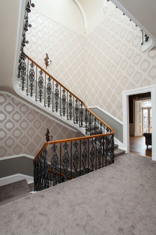 This is an example of a traditional painted wood u-shaped staircase in Edinburgh with painted wood risers.