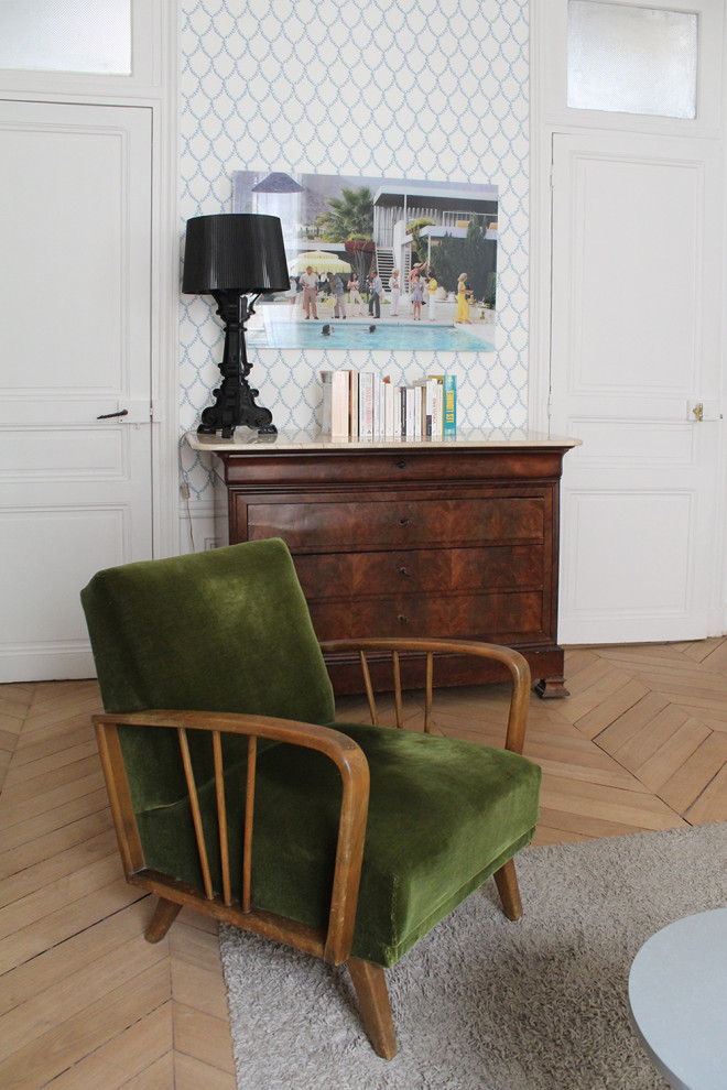 This is an example of a large traditional study in Paris with white walls, light hardwood flooring, a standard fireplace, a freestanding desk and wallpapered walls.