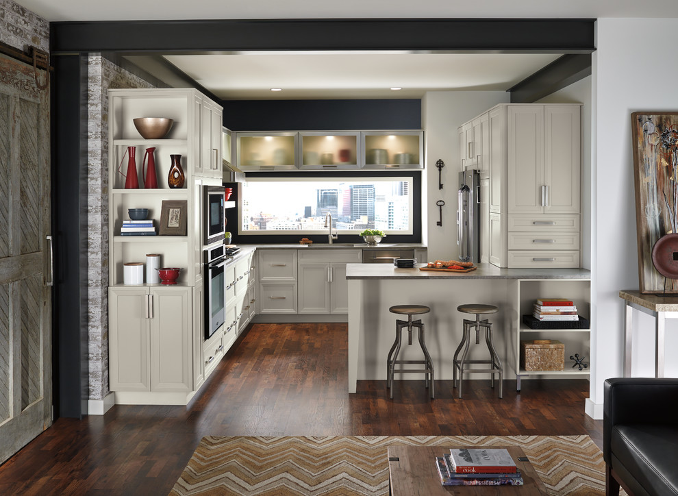 Design ideas for a small transitional u-shaped open plan kitchen in Toronto with recessed-panel cabinets, white cabinets, black splashback, stainless steel appliances, dark hardwood floors, an undermount sink, zinc benchtops and a peninsula.