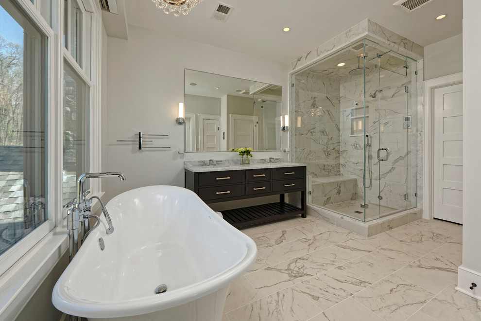 This is an example of a transitional bathroom in DC Metro with a claw-foot tub, grey walls, marble floors and marble benchtops.