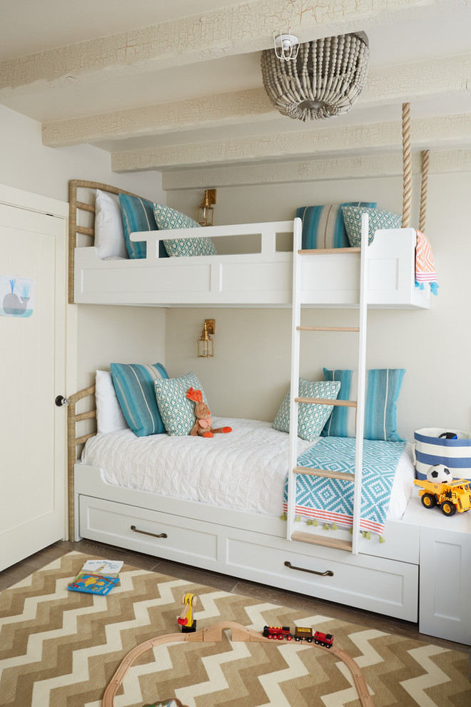 Design ideas for a mid-sized beach style gender-neutral kids' bedroom for kids 4-10 years old in San Francisco with grey walls, travertine floors and beige floor.