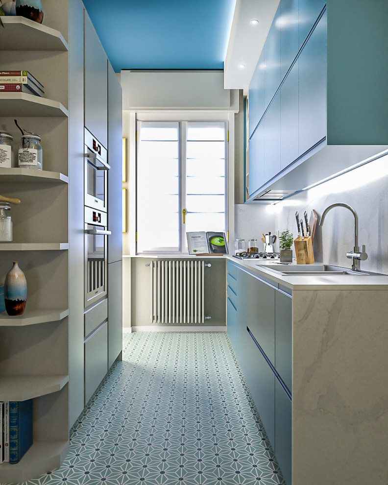 This is an example of a small contemporary galley separate kitchen in Milan with a double-bowl sink, flat-panel cabinets, blue cabinets, quartz benchtops, white splashback, engineered quartz splashback, stainless steel appliances, cement tiles, no island, green floor, white benchtop and recessed.