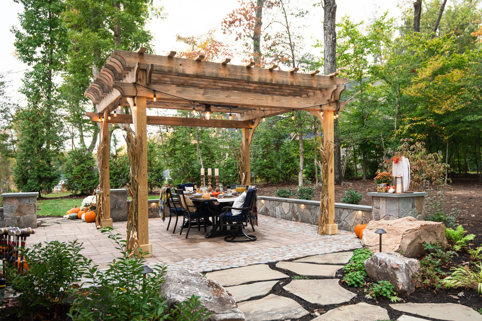 Patio - large rustic backyard concrete paver patio idea in Richmond with a fireplace and a pergola