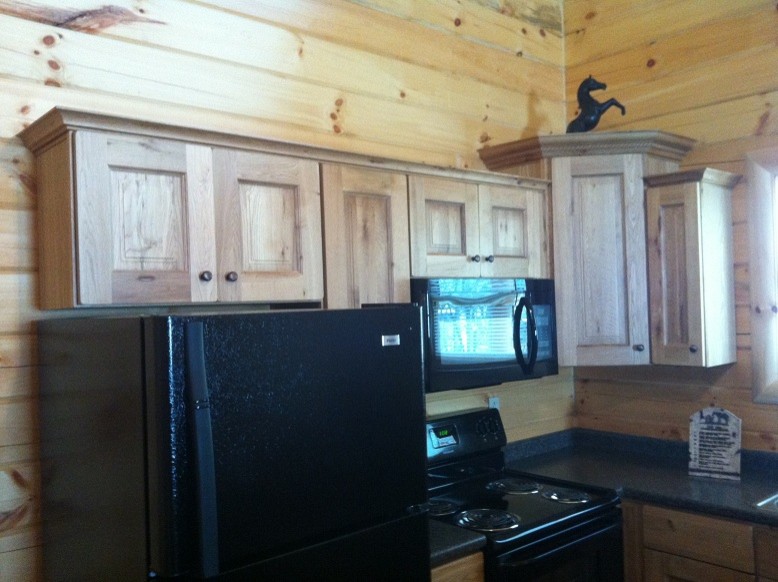 Inspiration for a mid-sized rustic l-shaped kitchen remodel with recessed-panel cabinets, distressed cabinets and laminate countertops