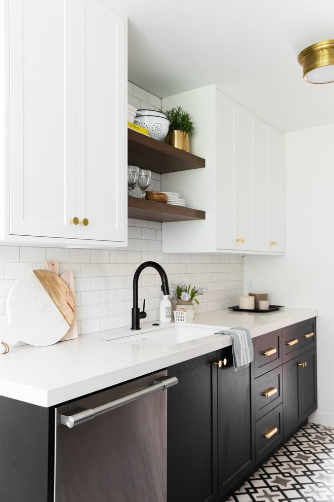 Photo of a mid-sized transitional l-shaped separate kitchen in Salt Lake City with a drop-in sink, white cabinets, white splashback, subway tile splashback, stainless steel appliances, cement tiles and multi-coloured floor.