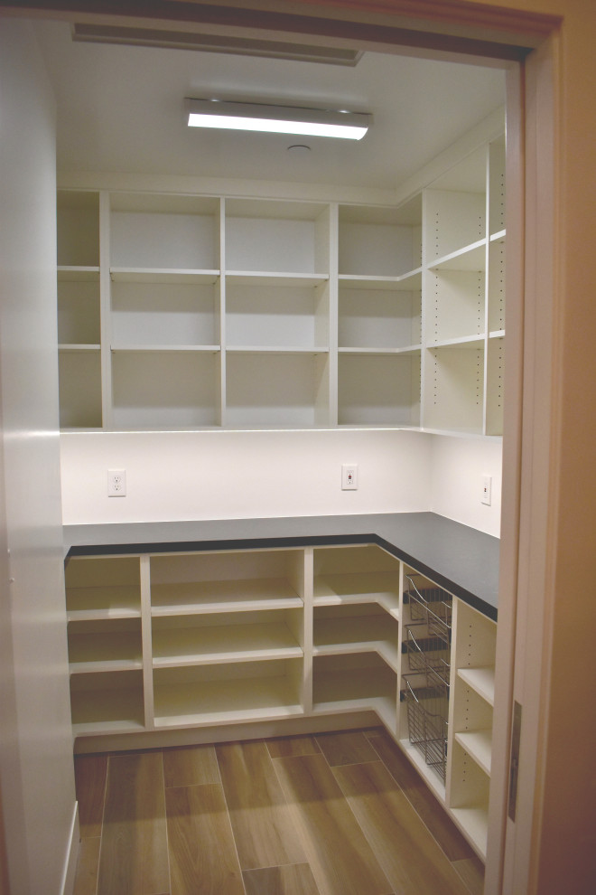 Photo of a large modern u-shaped kitchen pantry with open cabinets, white cabinets, ceramic floors, brown floor, quartz benchtops and black benchtop.
