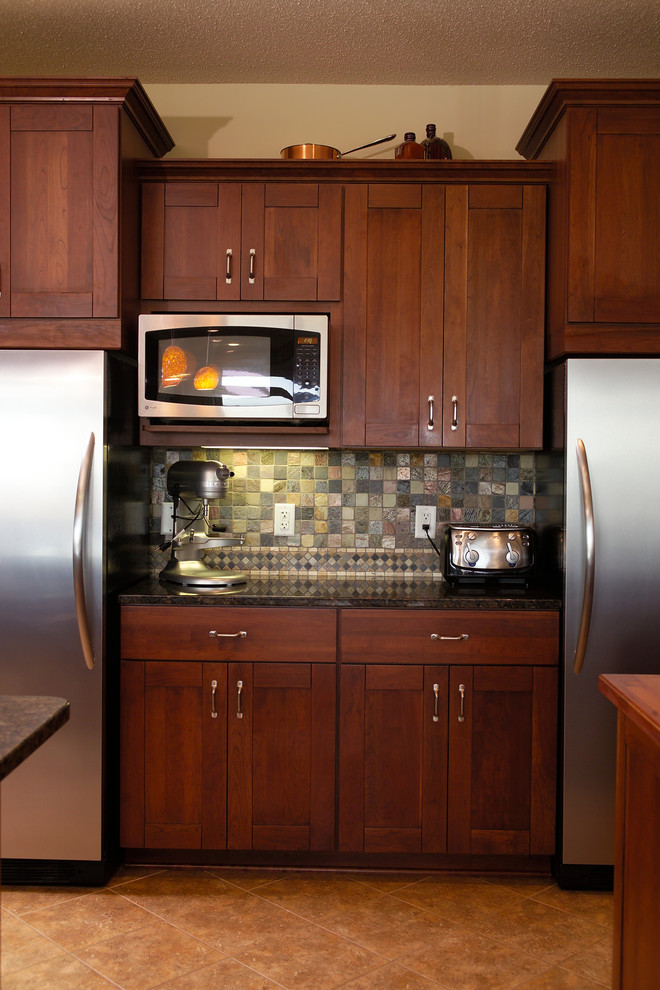 Example of a large transitional u-shaped porcelain tile open concept kitchen design with an undermount sink, recessed-panel cabinets, dark wood cabinets, granite countertops, gray backsplash, ceramic backsplash, stainless steel appliances and two islands