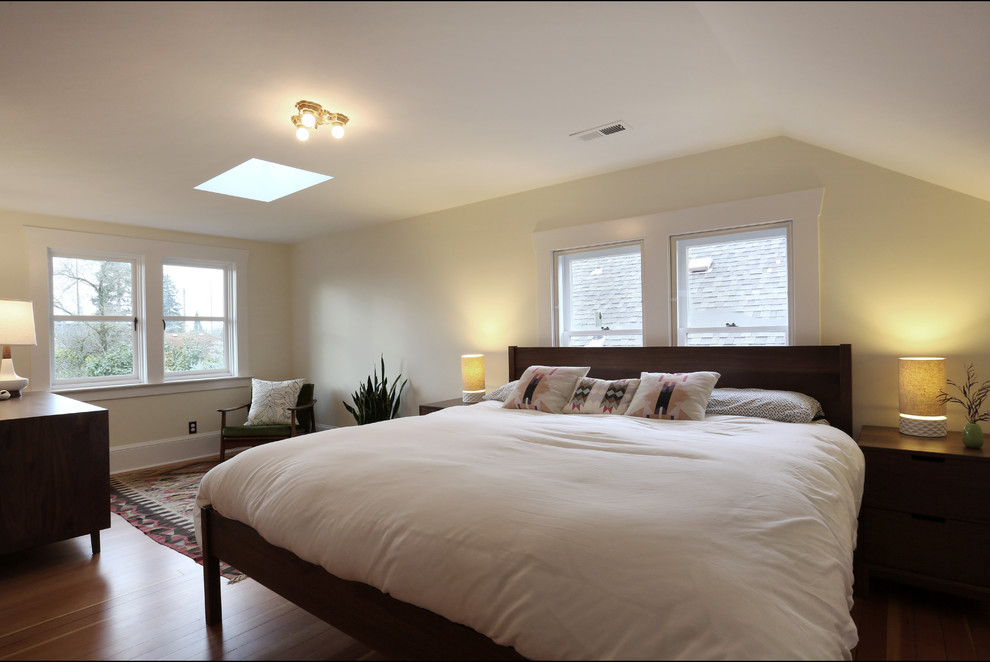 This is an example of a mid-sized traditional master bedroom in Portland with light hardwood floors.