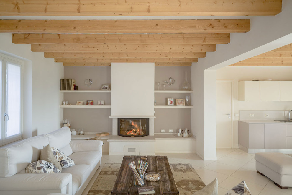 Contemporary open concept family room in Milan with white walls, ceramic floors, a standard fireplace and a plaster fireplace surround.