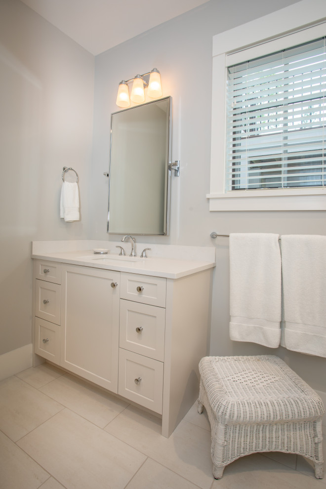 This is an example of a mid-sized traditional 3/4 bathroom in Other with white cabinets, grey walls, a drop-in sink, engineered quartz benchtops, white floor, a shower curtain and white benchtops.