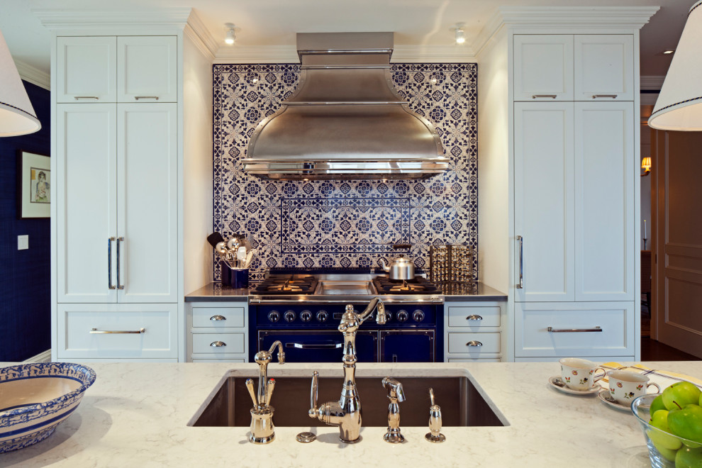 Inspiration for a transitional dark wood floor and brown floor enclosed kitchen remodel in Baltimore with an undermount sink, recessed-panel cabinets, white cabinets, stainless steel countertops, blue backsplash, stainless steel appliances, an island and black countertops