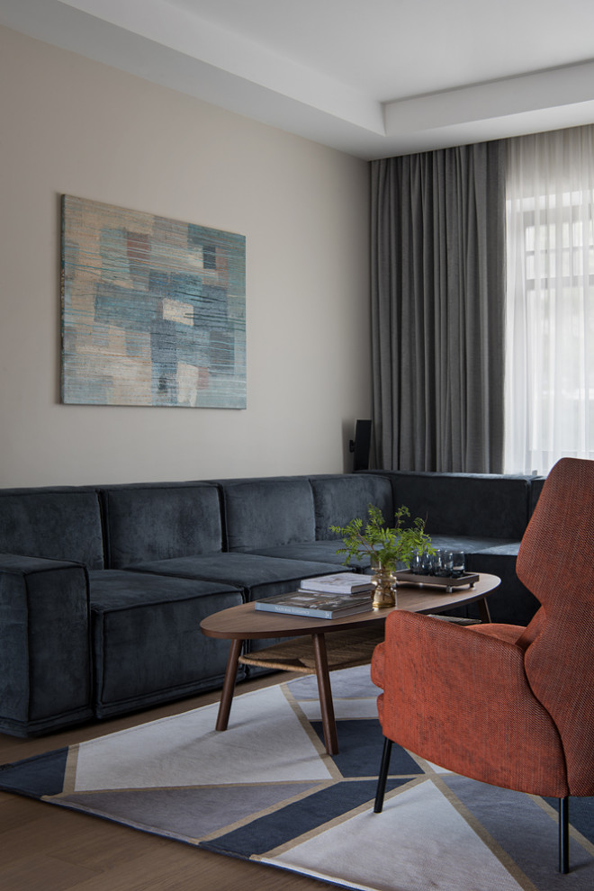 Photo of a mid-sized contemporary formal living room in Moscow with beige walls, medium hardwood floors, a standard fireplace, a stone fireplace surround, a wall-mounted tv, brown floor, recessed and panelled walls.