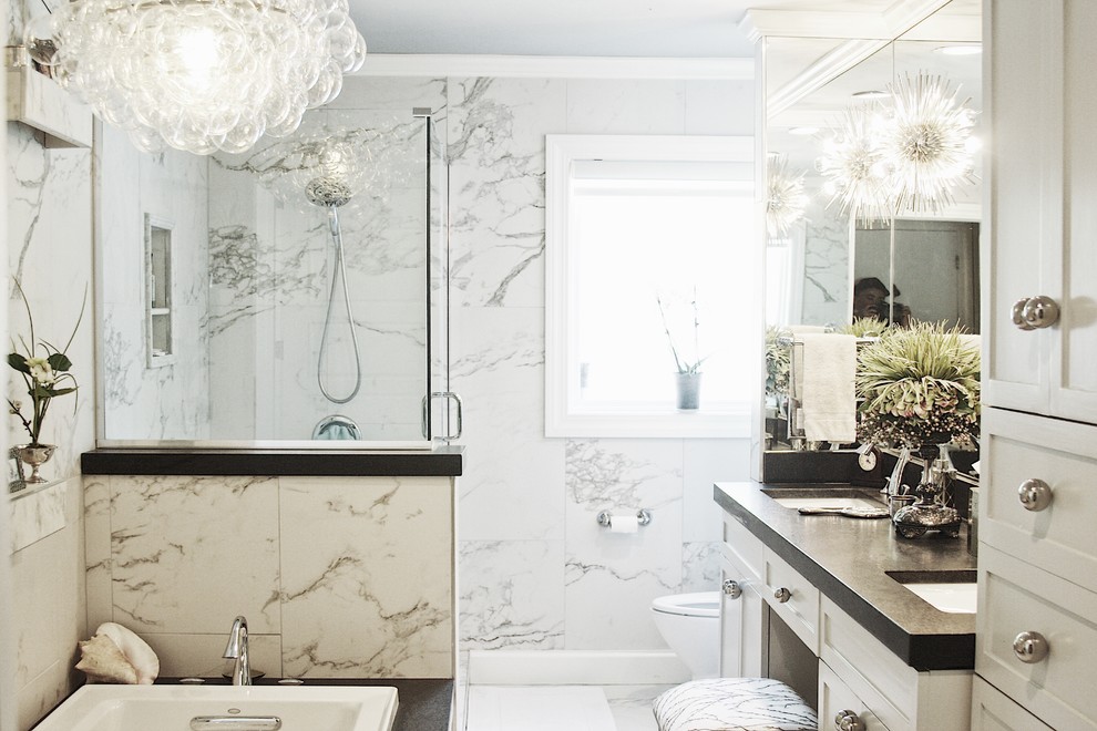Drop-in bathtub - large transitional master gray tile, white tile and porcelain tile porcelain tile and white floor drop-in bathtub idea with shaker cabinets, white cabinets, a two-piece toilet, white walls, an undermount sink, solid surface countertops and a hinged shower door