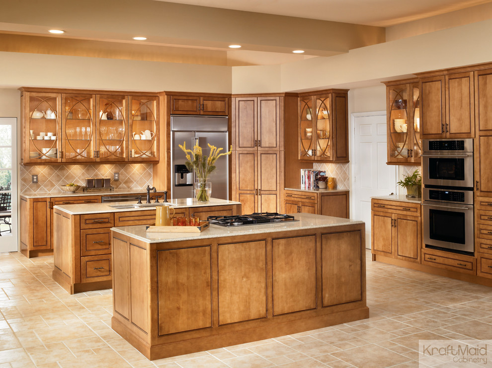Example of a large transitional l-shaped eat-in kitchen design in Detroit with raised-panel cabinets, white cabinets, stainless steel appliances and two islands