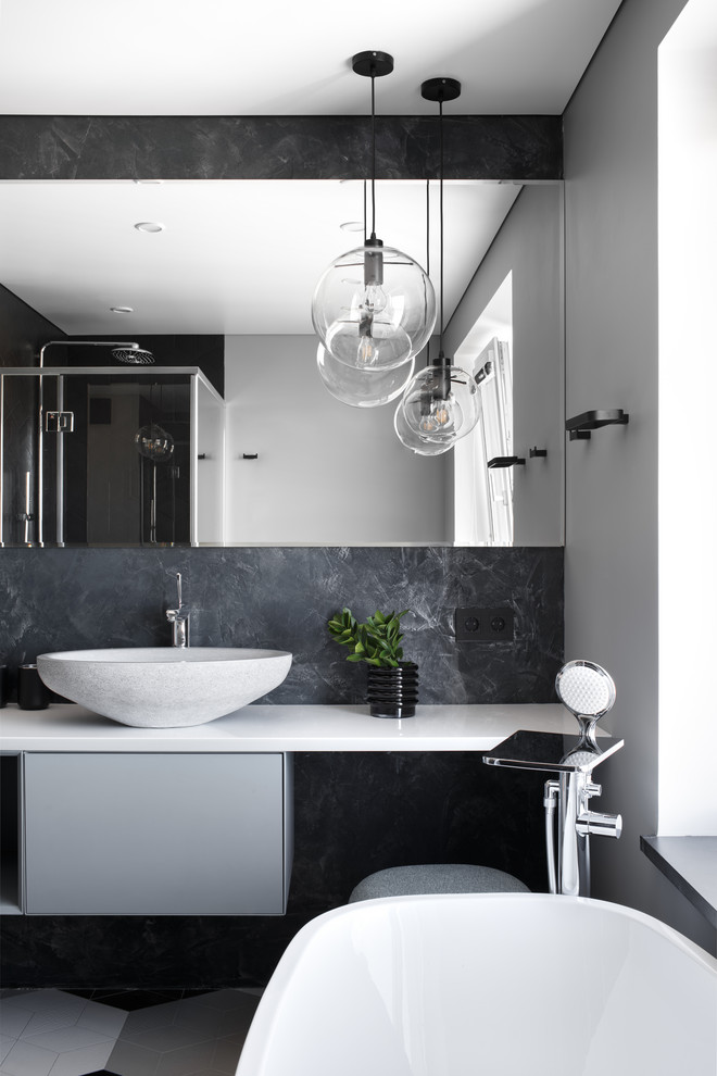 Inspiration for a contemporary master bathroom in Other with flat-panel cabinets, grey cabinets, a corner shower, gray tile, white walls, a vessel sink, grey floor, a hinged shower door and white benchtops.