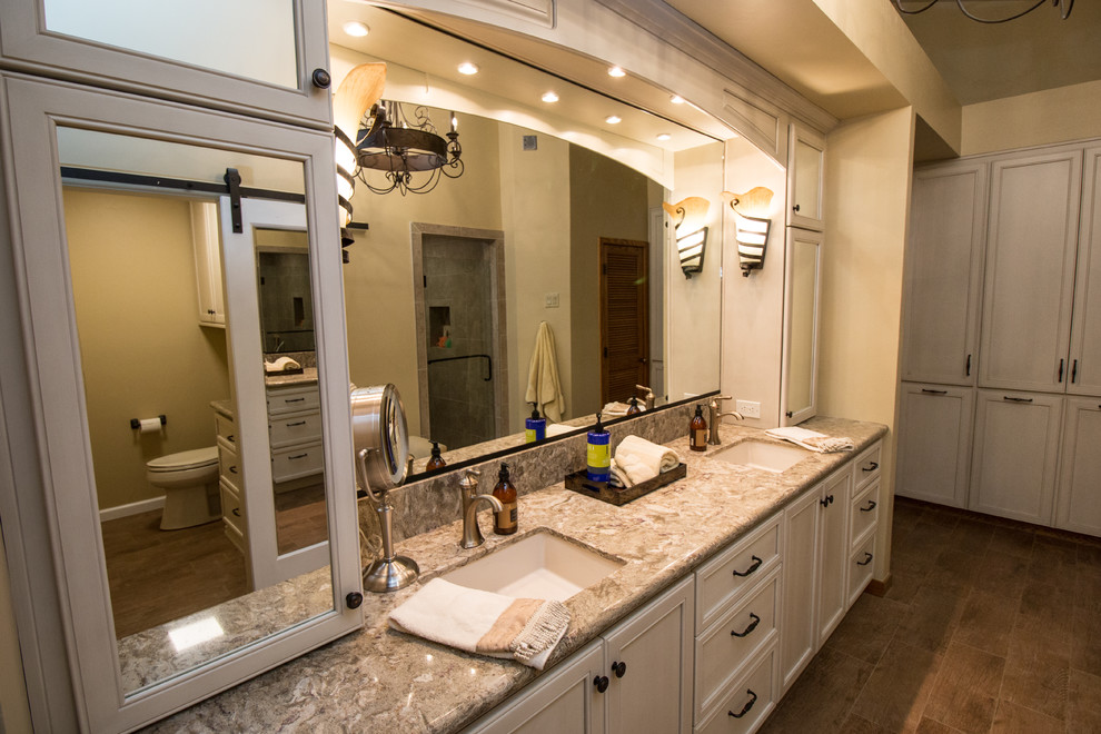 Large traditional master bathroom in Other with recessed-panel cabinets, beige cabinets, a drop-in tub, a two-piece toilet, beige tile, porcelain tile, beige walls, porcelain floors, an undermount sink and engineered quartz benchtops.