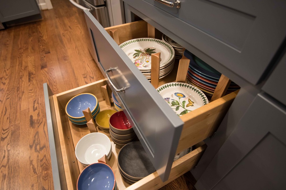 Mid-sized transitional u-shaped medium tone wood floor and brown floor eat-in kitchen photo in Raleigh with a single-bowl sink, shaker cabinets, gray cabinets, granite countertops, white backsplash, porcelain backsplash, stainless steel appliances, a peninsula and white countertops