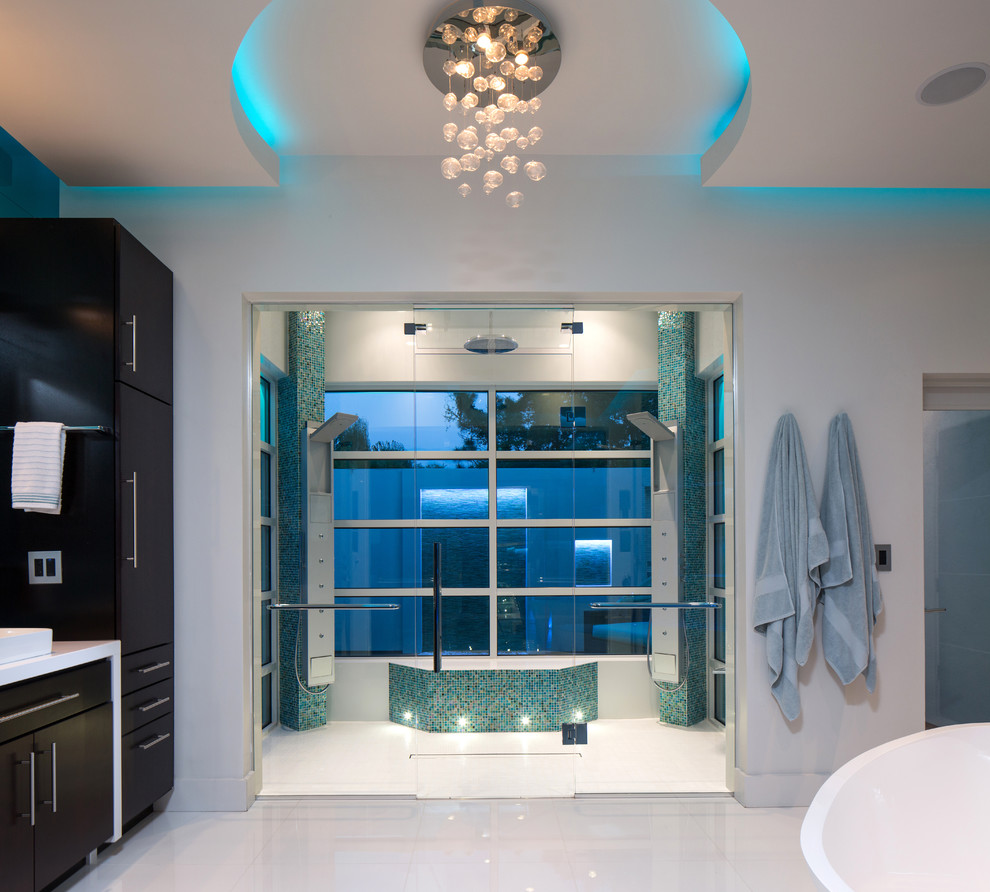 Contemporary master bathroom in Orlando with a vessel sink, flat-panel cabinets, dark wood cabinets, a curbless shower, multi-coloured tile, mosaic tile and white walls.