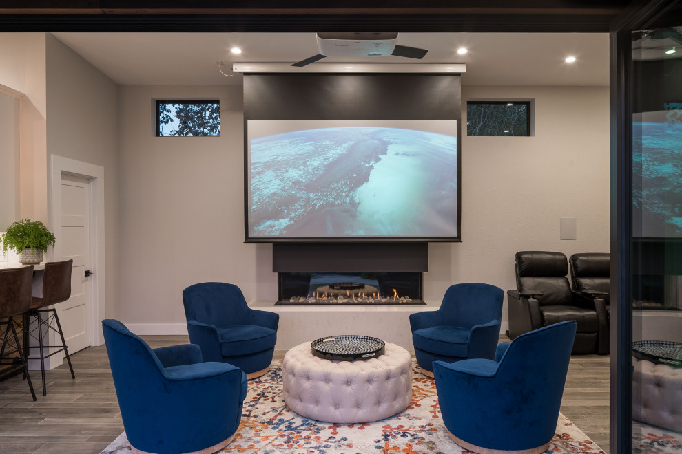 Modern enclosed home theatre in San Francisco with white walls, light hardwood floors, a projector screen and brown floor.
