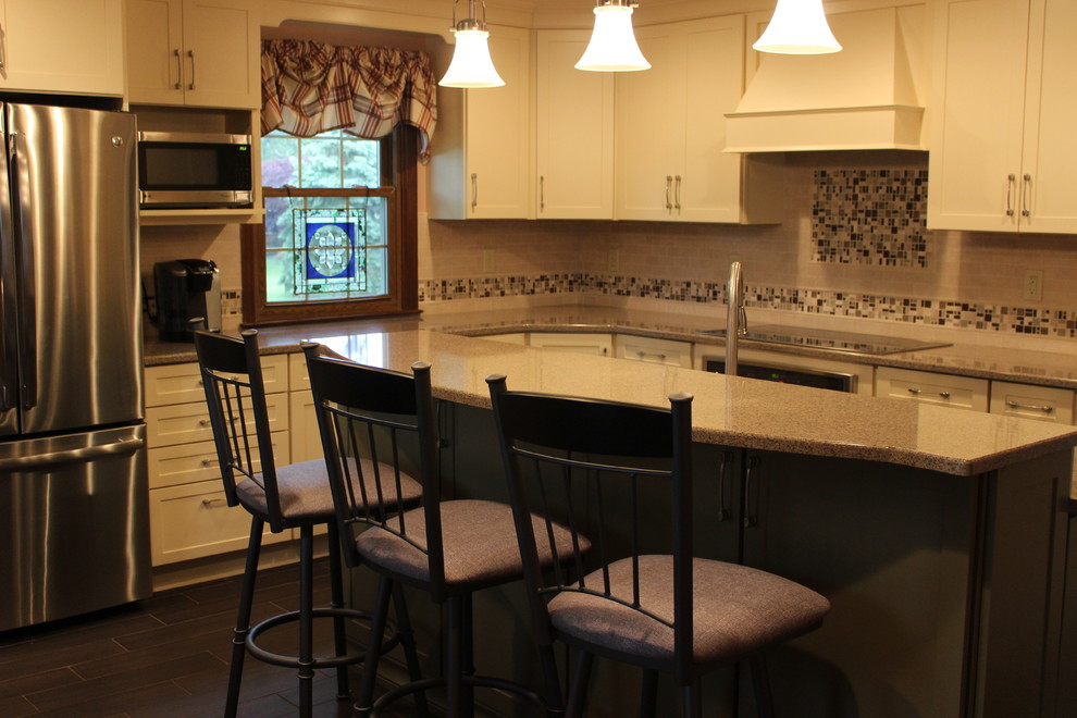 Eat-in kitchen - mid-sized traditional l-shaped dark wood floor eat-in kitchen idea in Philadelphia with an undermount sink, recessed-panel cabinets, white cabinets, quartz countertops, pink backsplash, subway tile backsplash, stainless steel appliances and an island
